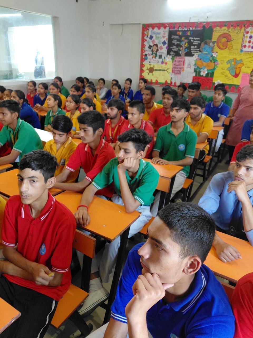 A classroom of students listening during a career guidance session
