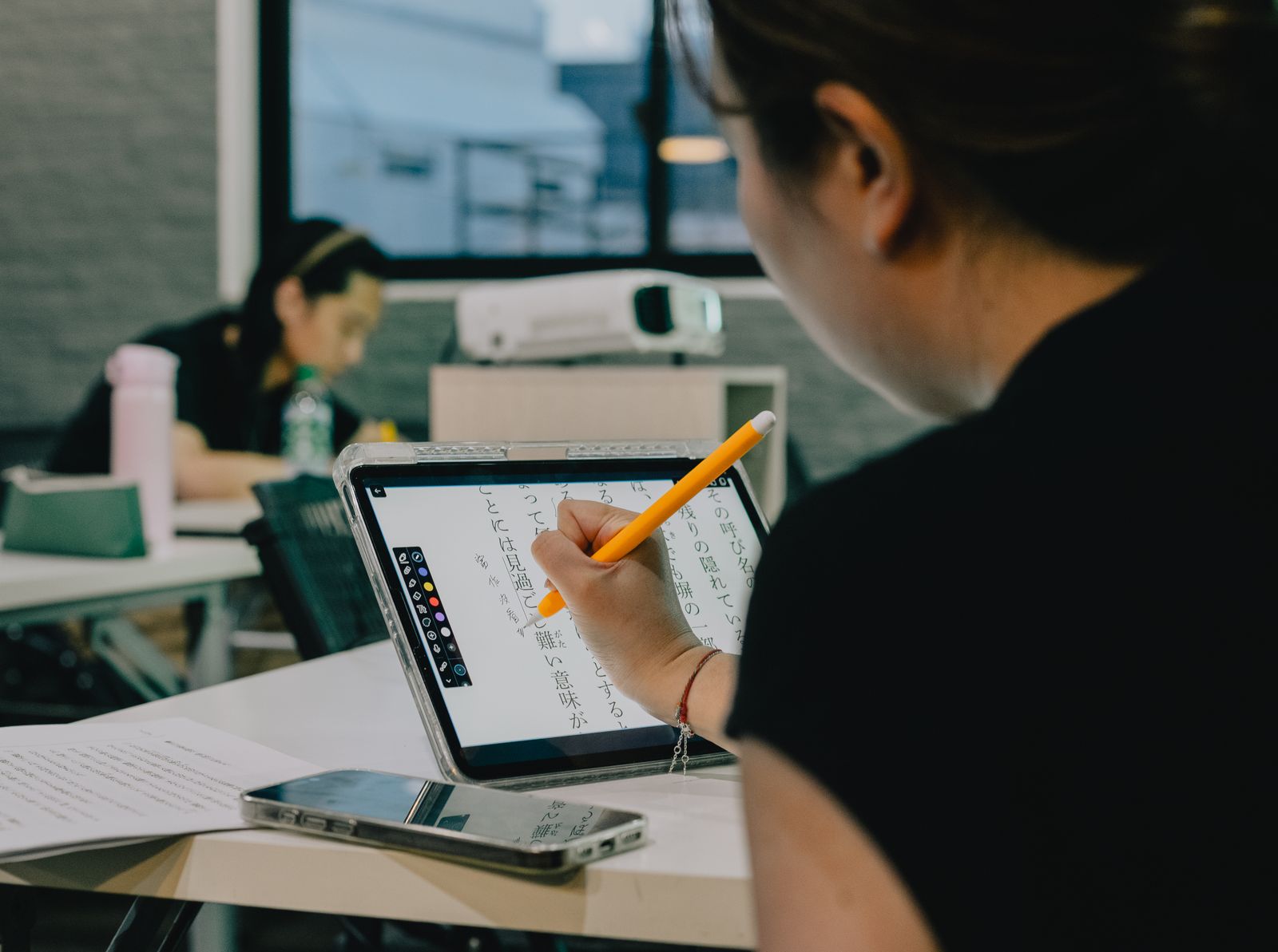 A student learning independently on a digital touchscreen panel in a futuristic, AI-assisted classroom